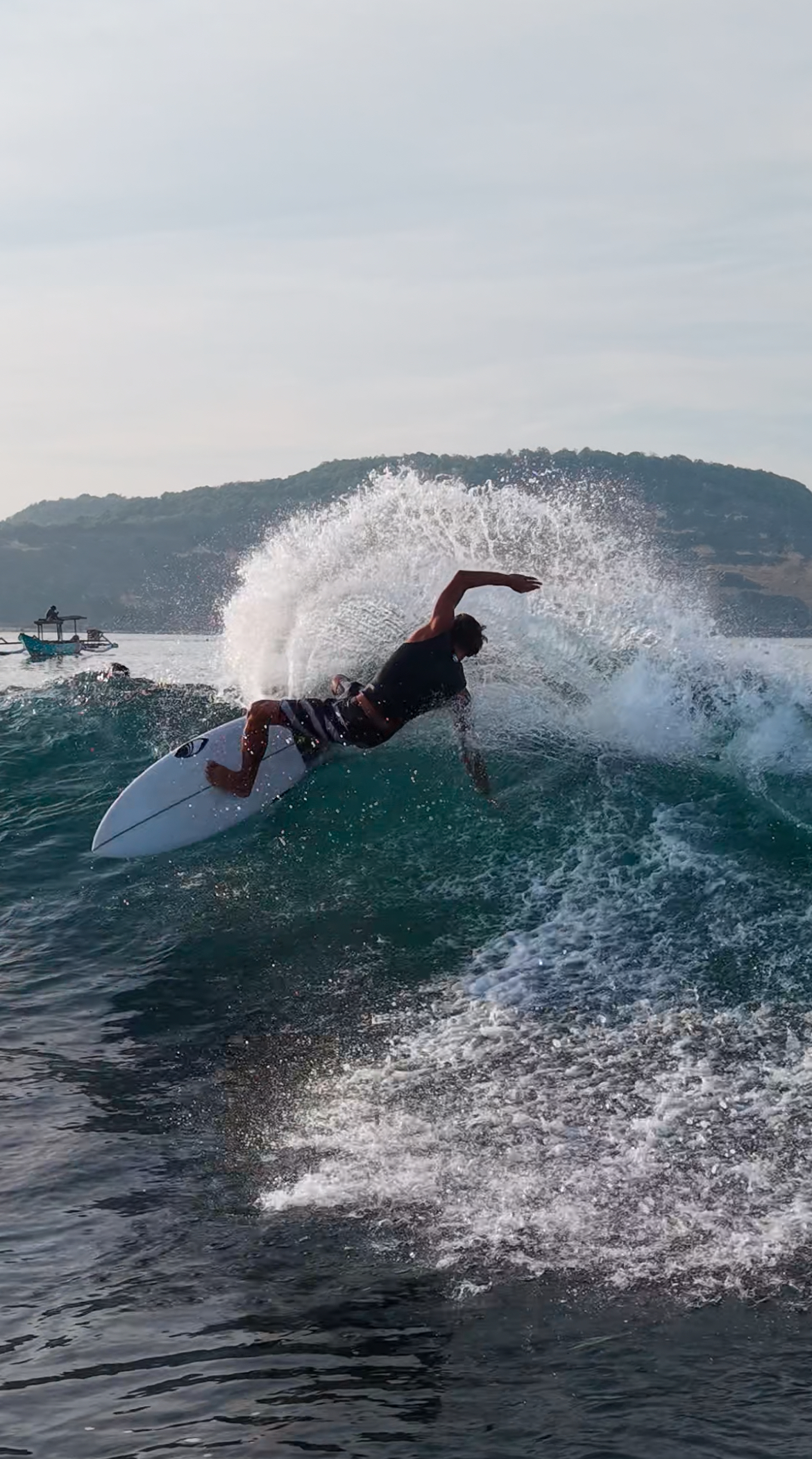 Surfing a clean wave in Gerupuk Bay